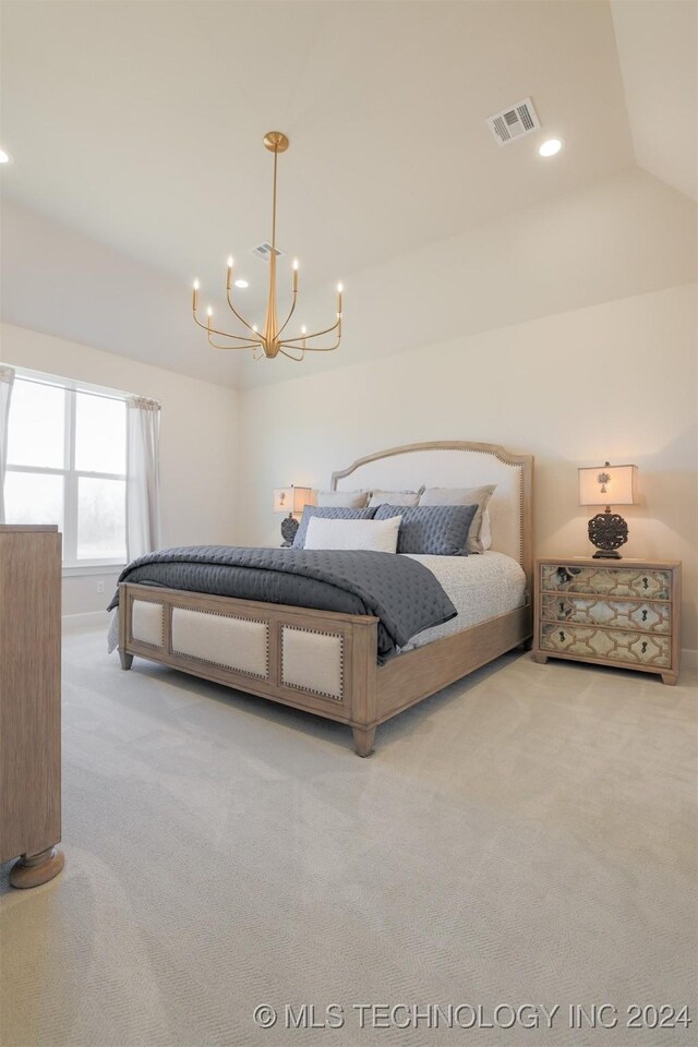 carpeted bedroom featuring vaulted ceiling and an inviting chandelier