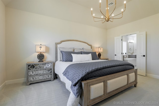 carpeted bedroom with connected bathroom and an inviting chandelier