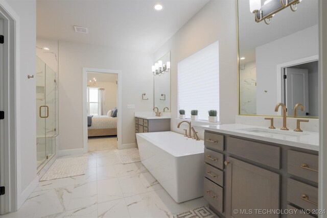 bathroom featuring vanity, independent shower and bath, and a notable chandelier