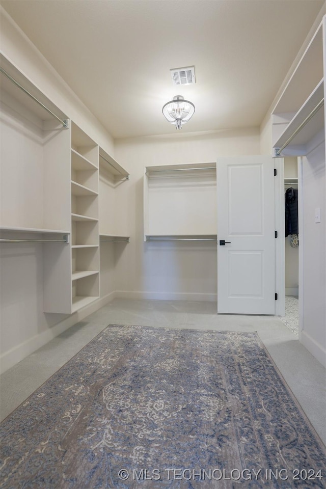 spacious closet featuring visible vents and carpet flooring