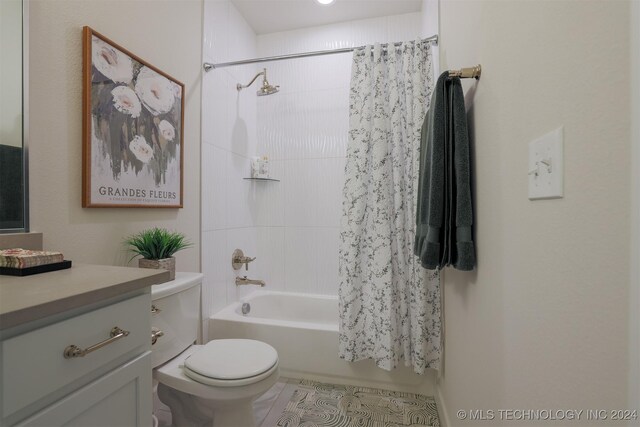 bathroom featuring vanity, shower / tub combo, and toilet