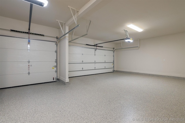 garage with a garage door opener and baseboards