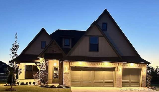 view of front facade with brick siding, driveway, a front yard, and a garage