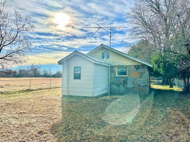 rear view of house featuring a yard