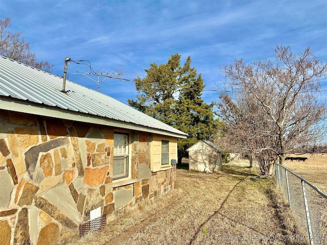 view of side of home with a storage unit