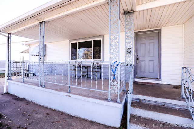 view of exterior entry with a porch