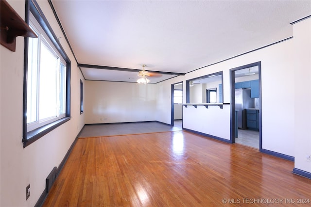 spare room with hardwood / wood-style flooring and ceiling fan