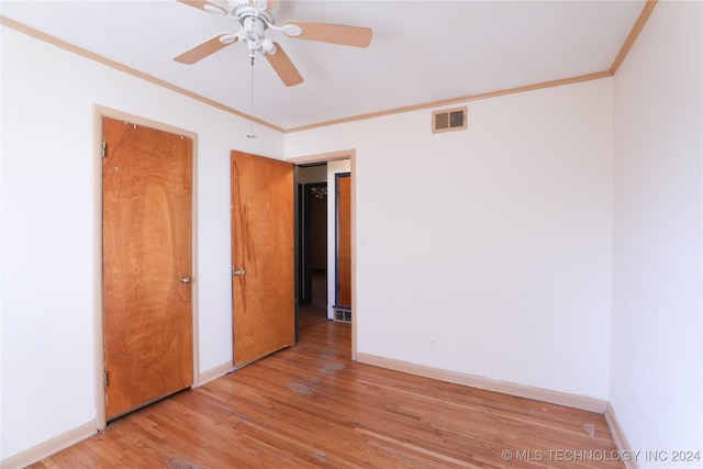 spare room featuring ceiling fan, crown molding, and light hardwood / wood-style floors