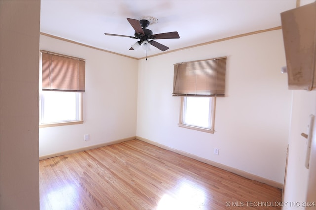 empty room with light hardwood / wood-style floors, plenty of natural light, ornamental molding, and ceiling fan