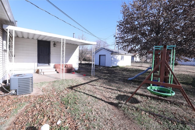 back of house with an outbuilding and central air condition unit