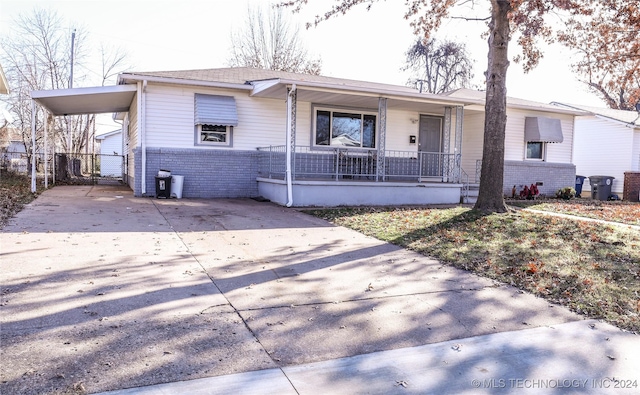 view of front facade with a porch and a carport