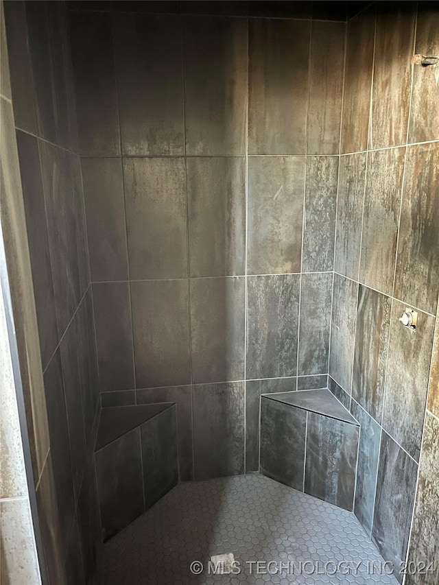 bathroom with tiled shower