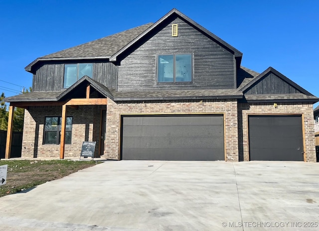 craftsman-style home featuring brick siding, concrete driveway, an attached garage, and a shingled roof