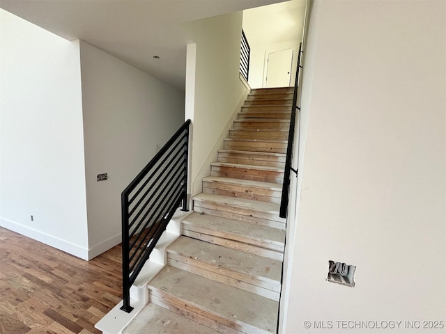 staircase featuring hardwood / wood-style floors