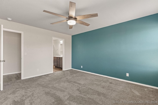 unfurnished bedroom featuring ensuite bath, ceiling fan, and carpet