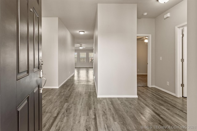 entrance foyer with ceiling fan and dark wood-type flooring