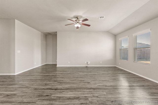 spare room with dark hardwood / wood-style flooring, ceiling fan, and lofted ceiling