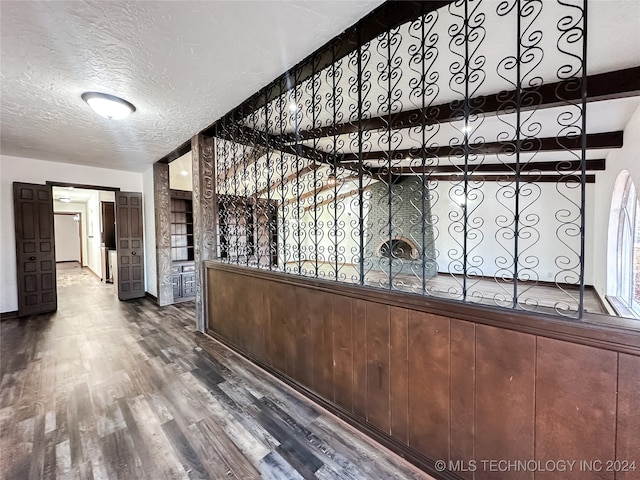 interior space featuring wood-type flooring and a textured ceiling