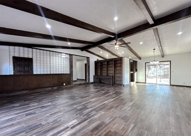 unfurnished living room featuring lofted ceiling with beams, a textured ceiling, and hardwood / wood-style flooring