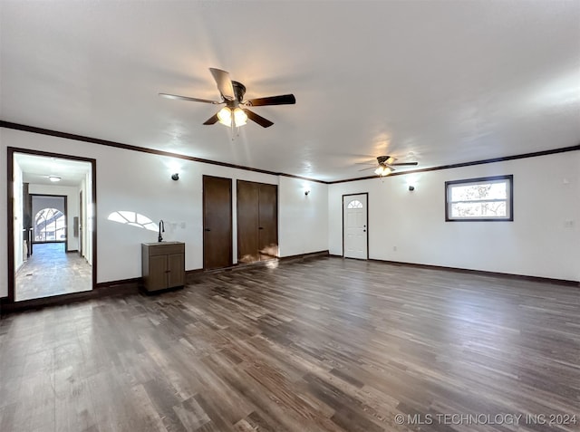 empty room featuring dark hardwood / wood-style floors, ceiling fan, and crown molding