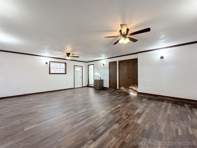 interior space featuring ceiling fan, dark hardwood / wood-style flooring, and crown molding