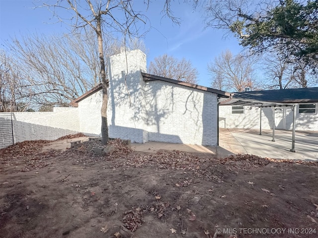 view of property exterior with a patio