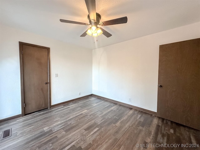 empty room with hardwood / wood-style flooring and ceiling fan