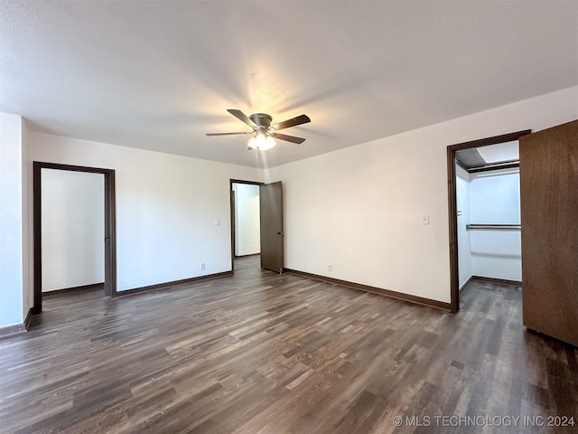 empty room featuring ceiling fan and dark hardwood / wood-style flooring