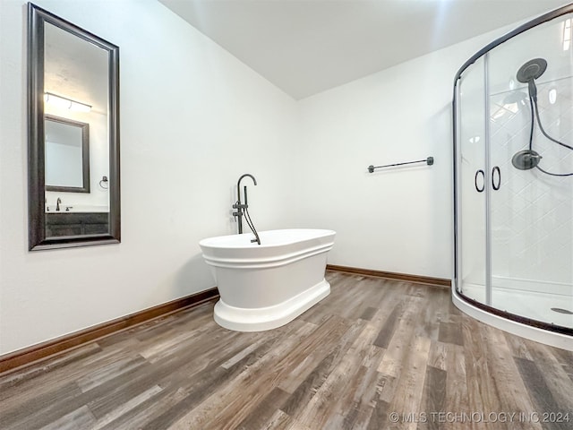 bathroom with hardwood / wood-style floors and plus walk in shower