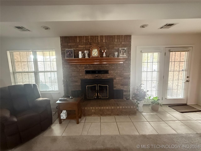 tiled living room with a brick fireplace