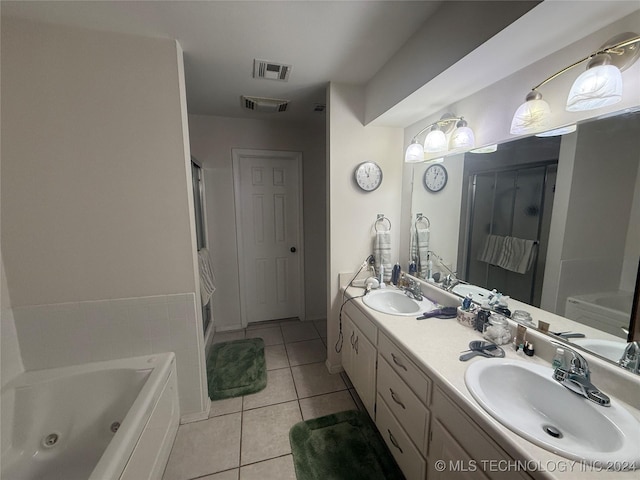 bathroom featuring tile patterned flooring, shower with separate bathtub, and vanity