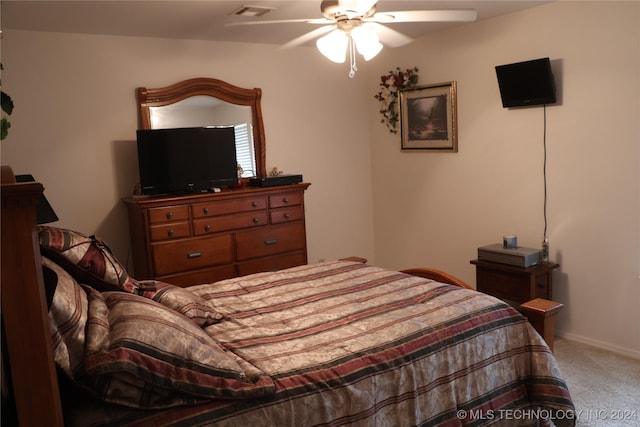 carpeted bedroom featuring ceiling fan and vaulted ceiling