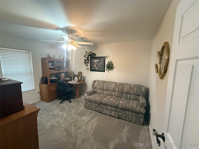 carpeted office space featuring ceiling fan