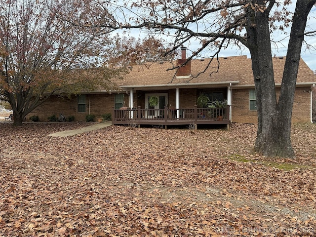 back of house featuring a wooden deck