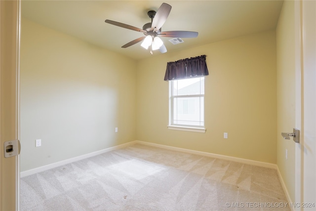 unfurnished room featuring light carpet and ceiling fan