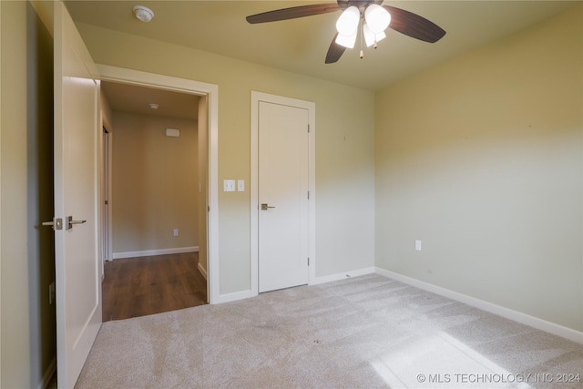 unfurnished bedroom with ceiling fan and light carpet