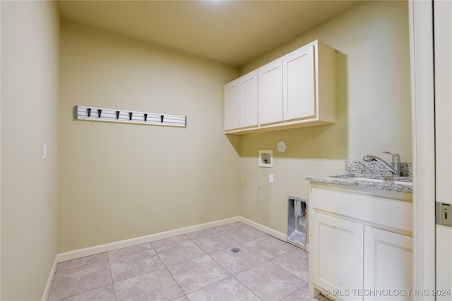 clothes washing area featuring cabinets, hookup for a washing machine, light tile patterned flooring, and sink