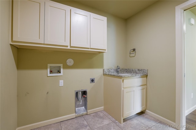 laundry room featuring cabinets, hookup for a washing machine, gas dryer hookup, electric dryer hookup, and light tile patterned floors