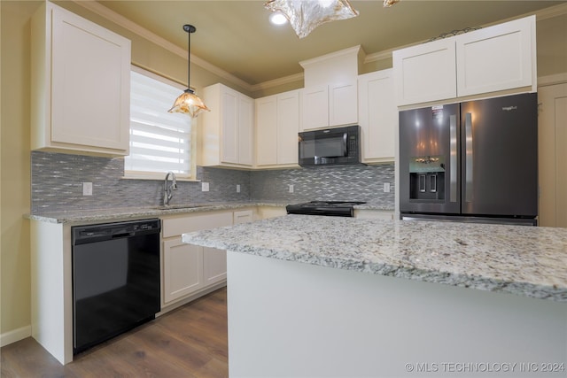 kitchen featuring pendant lighting, dark wood-type flooring, black appliances, ornamental molding, and white cabinetry