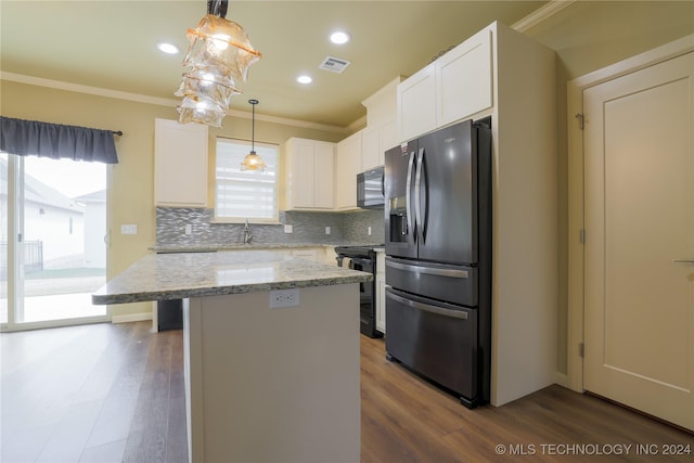 kitchen featuring dark hardwood / wood-style floors, white cabinetry, hanging light fixtures, and appliances with stainless steel finishes