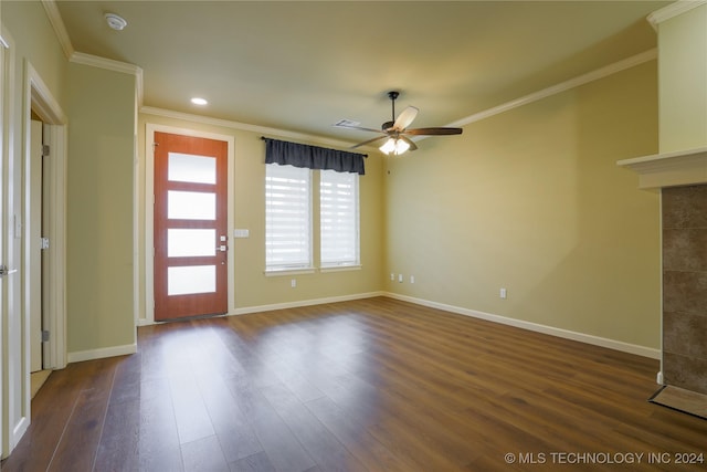 foyer entrance with ornamental molding, ceiling fan, and dark wood-type flooring