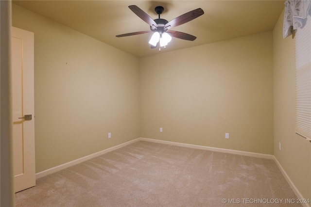 spare room with light carpet and ceiling fan