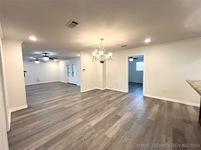 interior space featuring dark hardwood / wood-style floors, an inviting chandelier, and ornamental molding