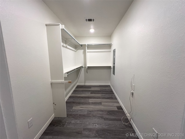 walk in closet featuring dark hardwood / wood-style flooring and electric panel