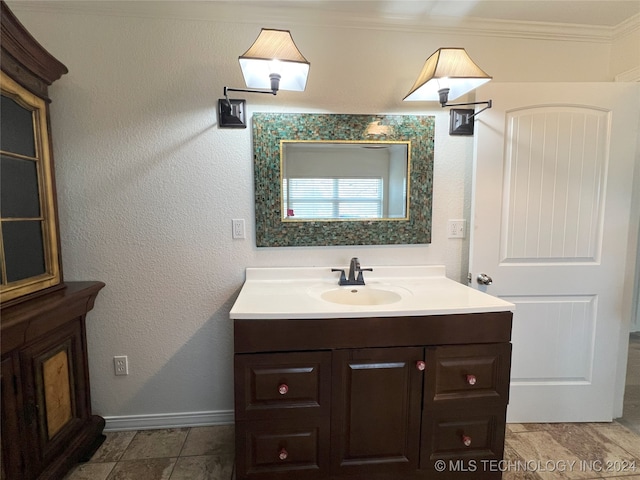 bathroom with vanity and crown molding