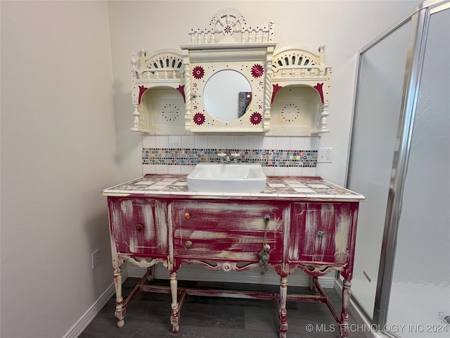 bathroom with vanity and tasteful backsplash