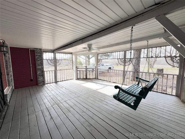 wooden terrace with ceiling fan and covered porch