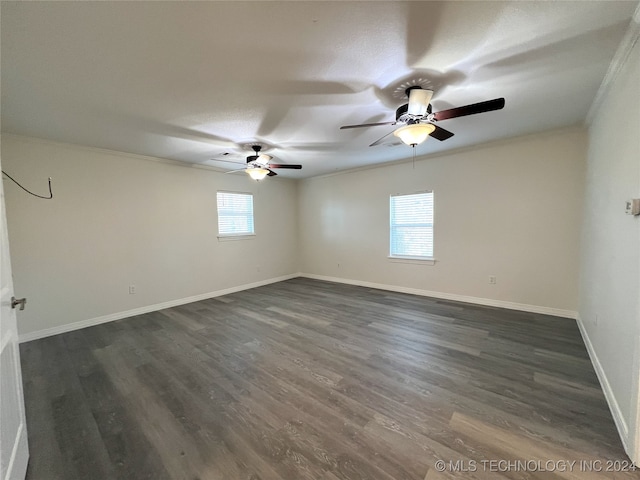 unfurnished room with crown molding and dark hardwood / wood-style flooring