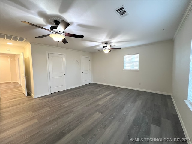 unfurnished bedroom with crown molding, ceiling fan, and dark wood-type flooring