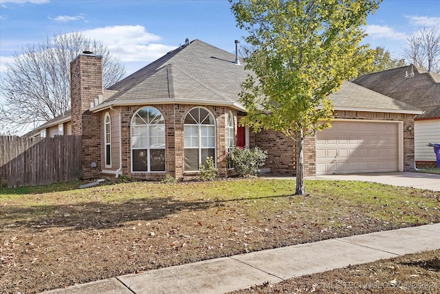 view of front of house with a garage and a front yard